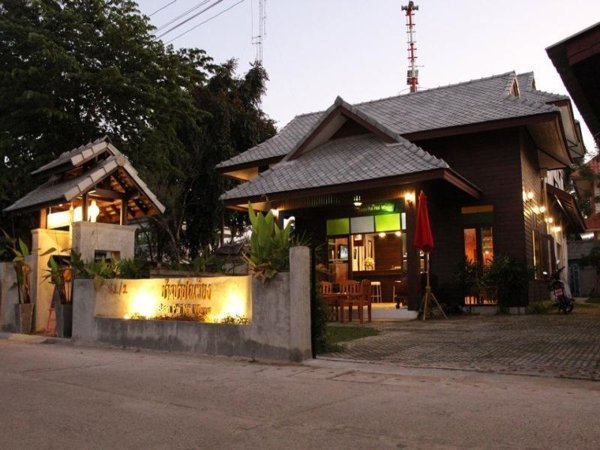 Baan Pai Nai Wieng entrance illuminated at dusk