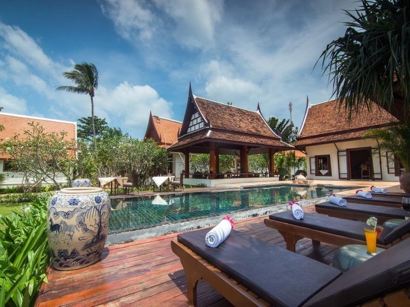 Swimming pool and Thai-roofed buildings at Baan Thai Lanta Resort