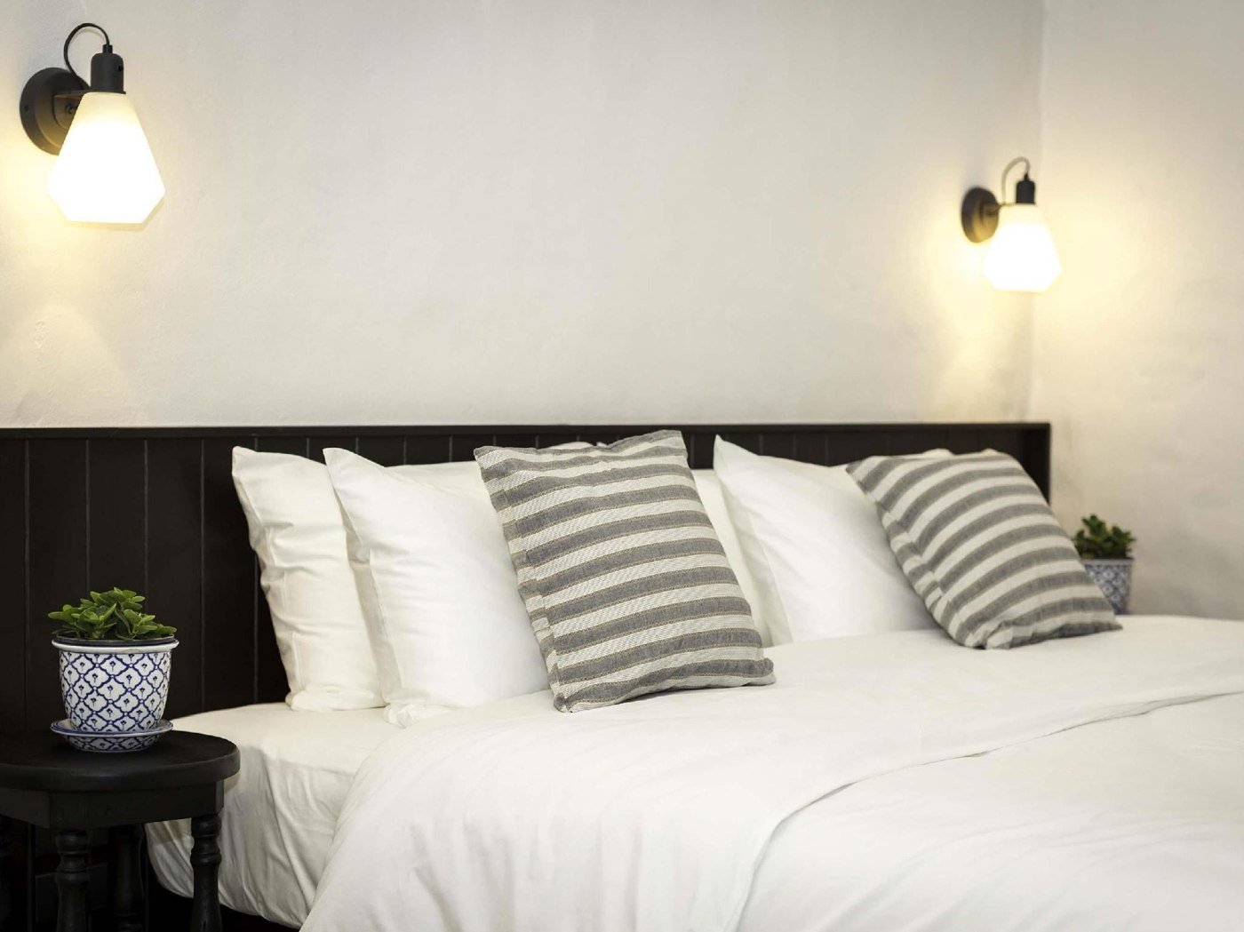 Double bedroom with wall lights at Chotana Villa