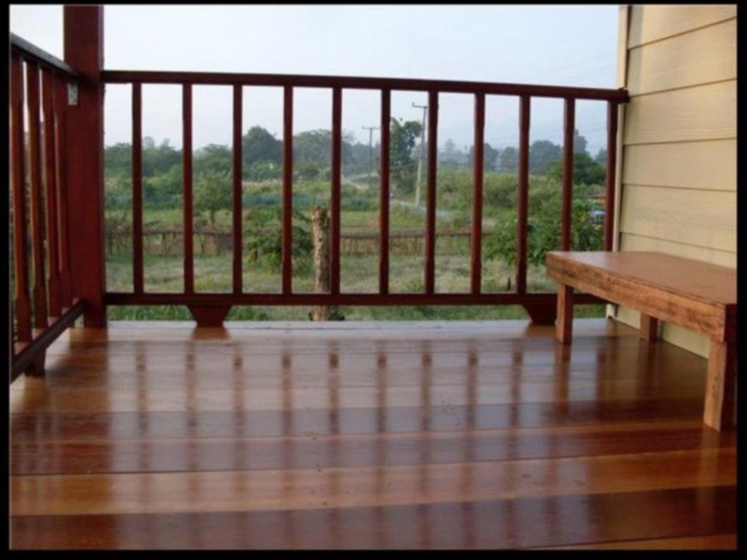 Wooden balcony and bench at Churn Yuen Pai by Gampanat Guesthouse