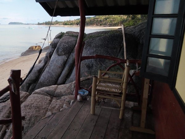 Bungalow terrace beside shoreline rocks at Golden Beach Resort Koh Phangan