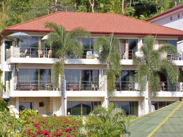 Balconied Mountain Seaview Luxury Apartments building with a red roof