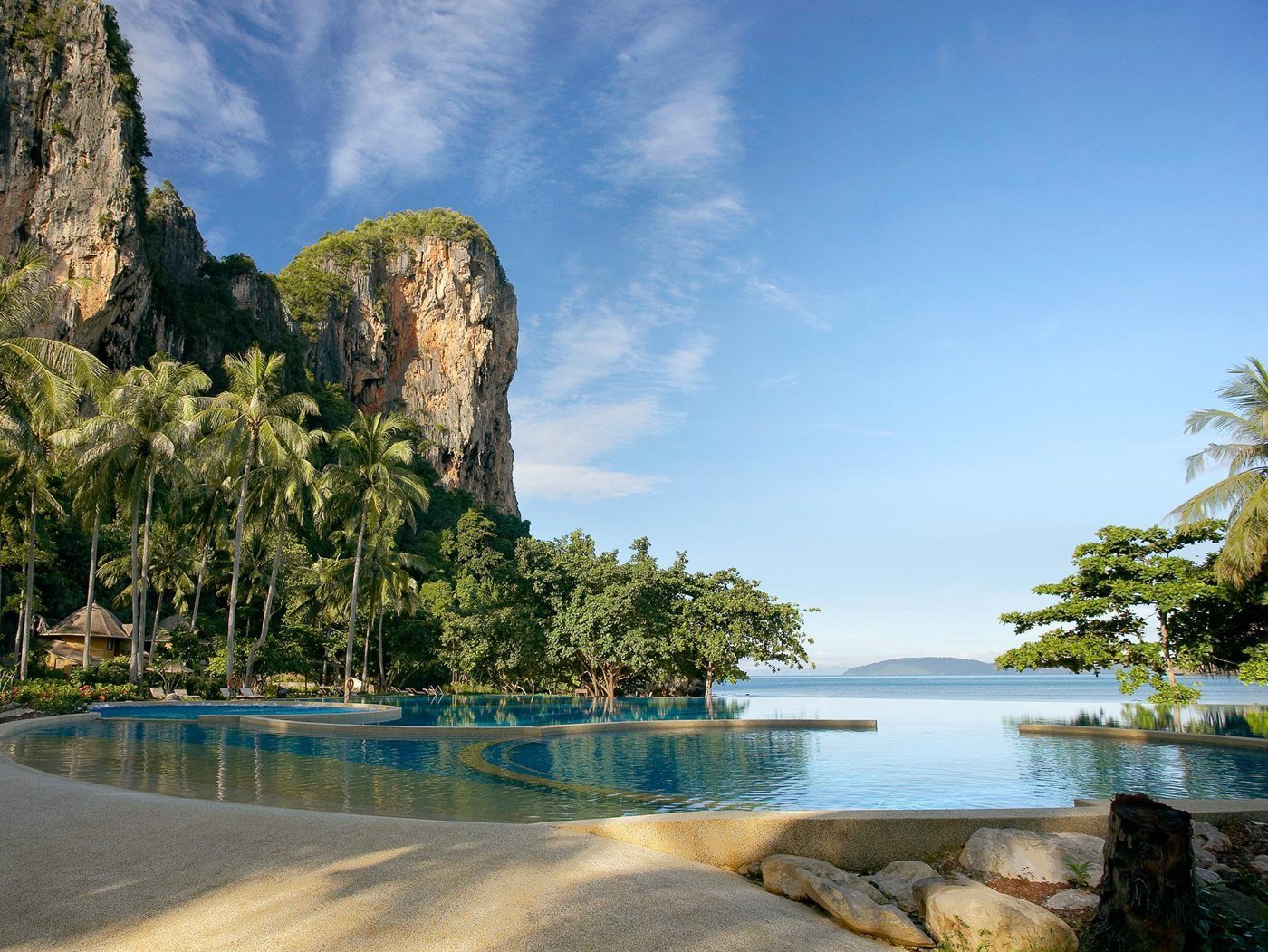 Swimming pool beside limestone cliffs and palms at Rayavadee
