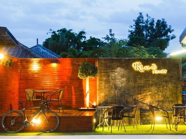 Riad Resort entrance wall and outdoor seating at dusk