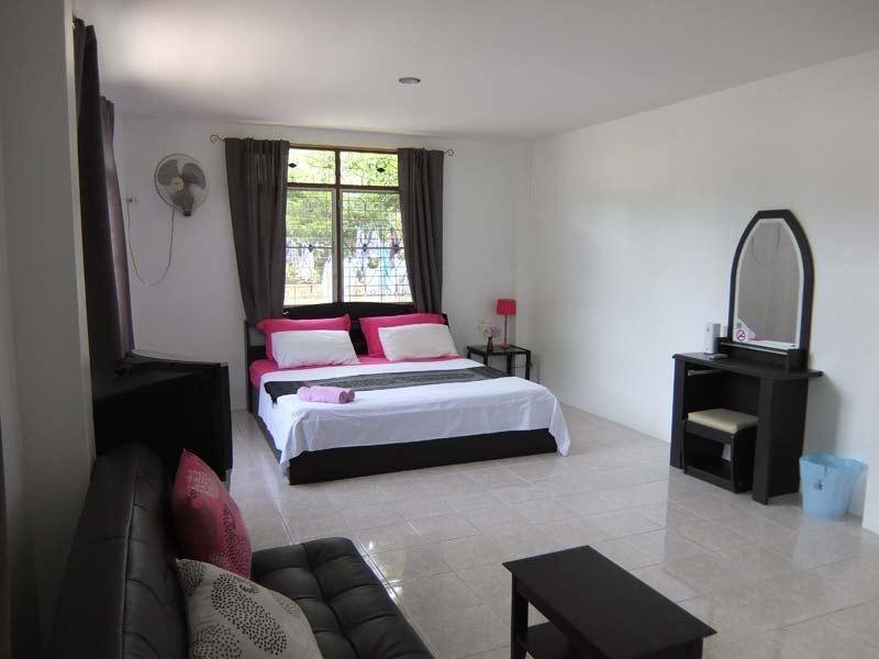 Double bed and sofa inside a Similan Hotel room