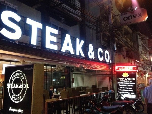 Steak & Co. illuminated restaurant frontage at night