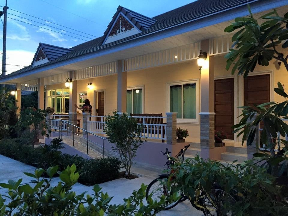 Guestroom row and planted entrance at Suksopha Resort