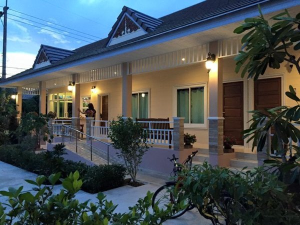 Guestroom row and planted entrance at Suksopha Resort