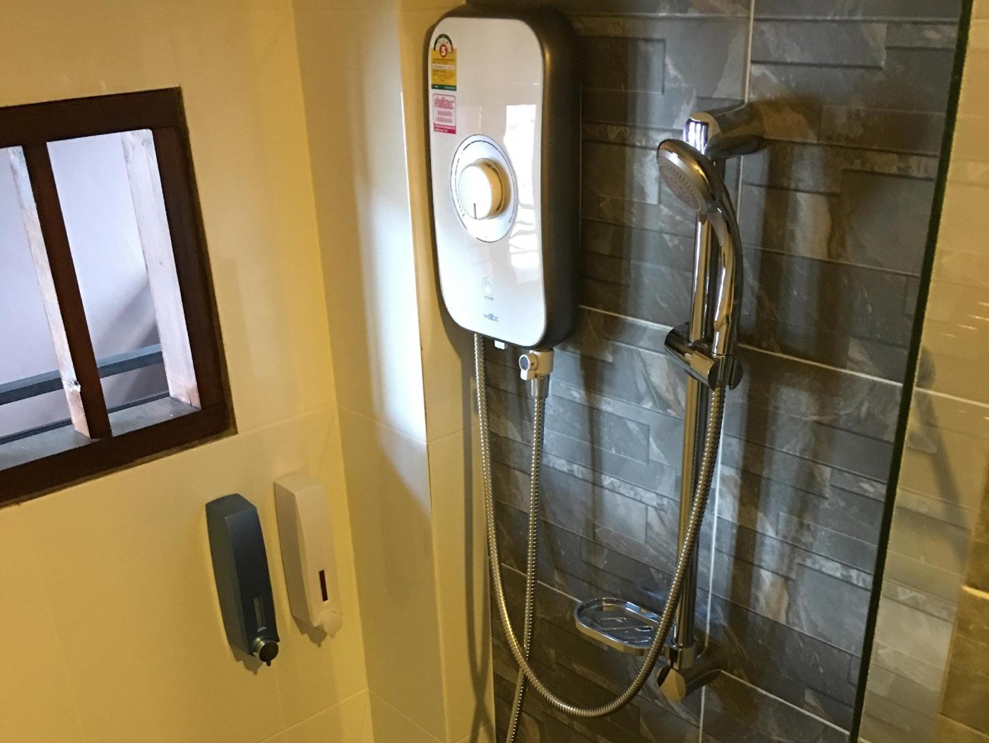 Wall-mounted water heater and shower at The Morning Minihouse Aonang