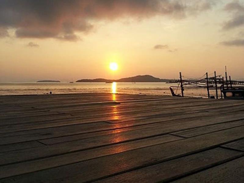 Sunrise over the shared timber deck at The Old Times Lanta